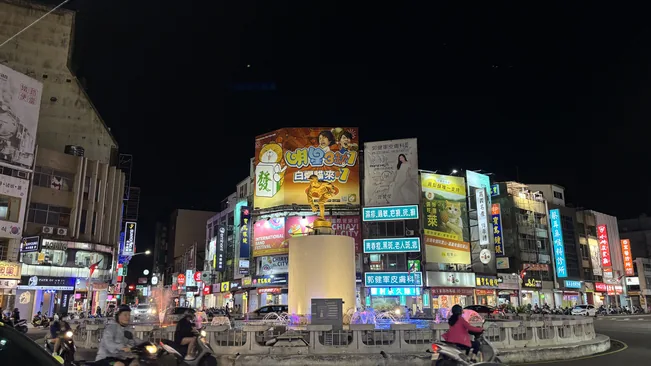 嘉義文化路夜市入夜後亮起整排招牌，街上人潮往來